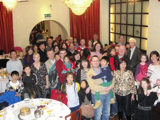 Ambassador Tseng and his wife and children are pictured with the adoptive families at The Imperial Restaurant
