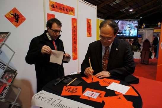 Representative Harry Tseng demonstrating Chinese Calligraphy