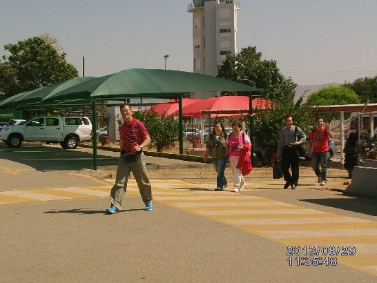 台中天主教國際志工親善大使團8月29日搭乘下午13:50的班機返國趙醫師榮勤帶團走向出境室，向送機的蔣副參事招手非常高興。