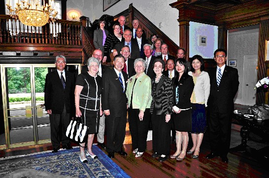 A group photo on the staircase is a tradition of the Twin Oaks Tour