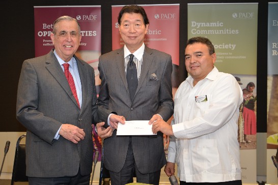 Rep. Shen (middle) presents the donation to PADF Executive Director John Sanbrailo (left) and Nestor Méndez, Belize Ambassador to the United States and Permanent Representative to the OAS (right).