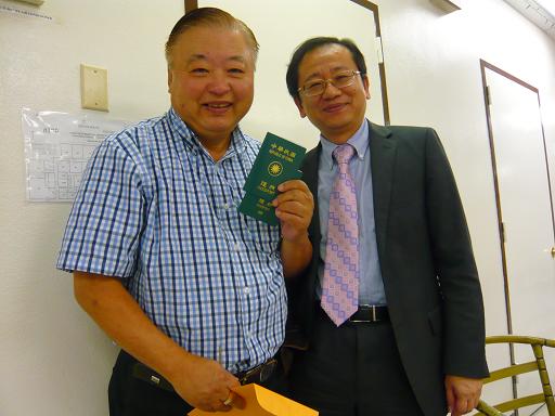 Secretary Chang takes picture with passport renewal applicant