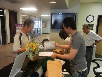 Officers of Taipei Economic &amp; Cultural Office accept applications for visas and passports at the Houston Cultural Center