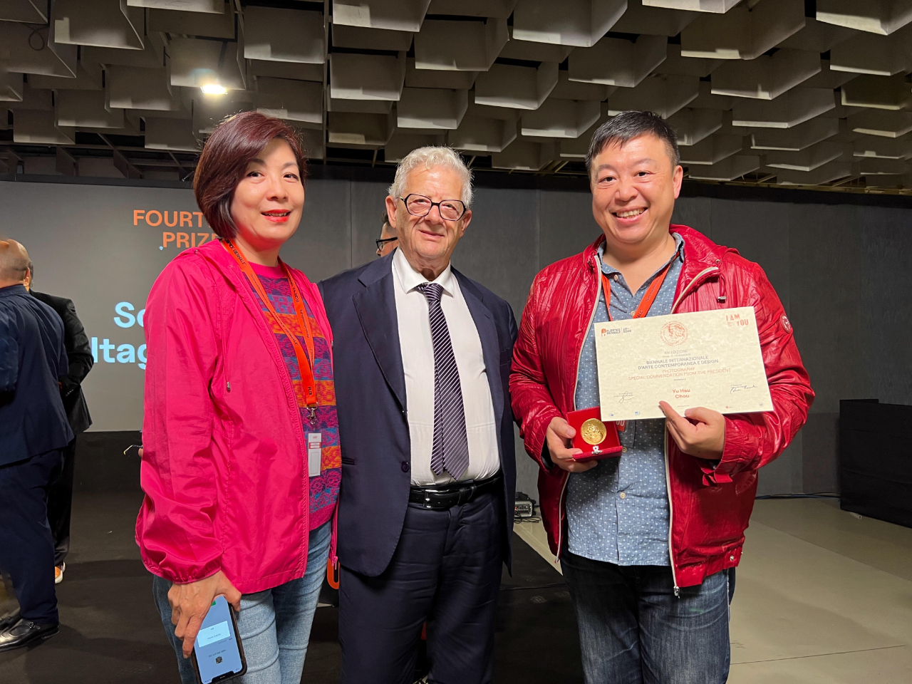 周有煦(右)以獨樹一格攝影作品「Essere」榮獲第14屆佛羅倫斯雙年展攝影類主席特別提名獎，並與大會主席Piero Celona(中)合影紀念。(照片為周有熙提供)