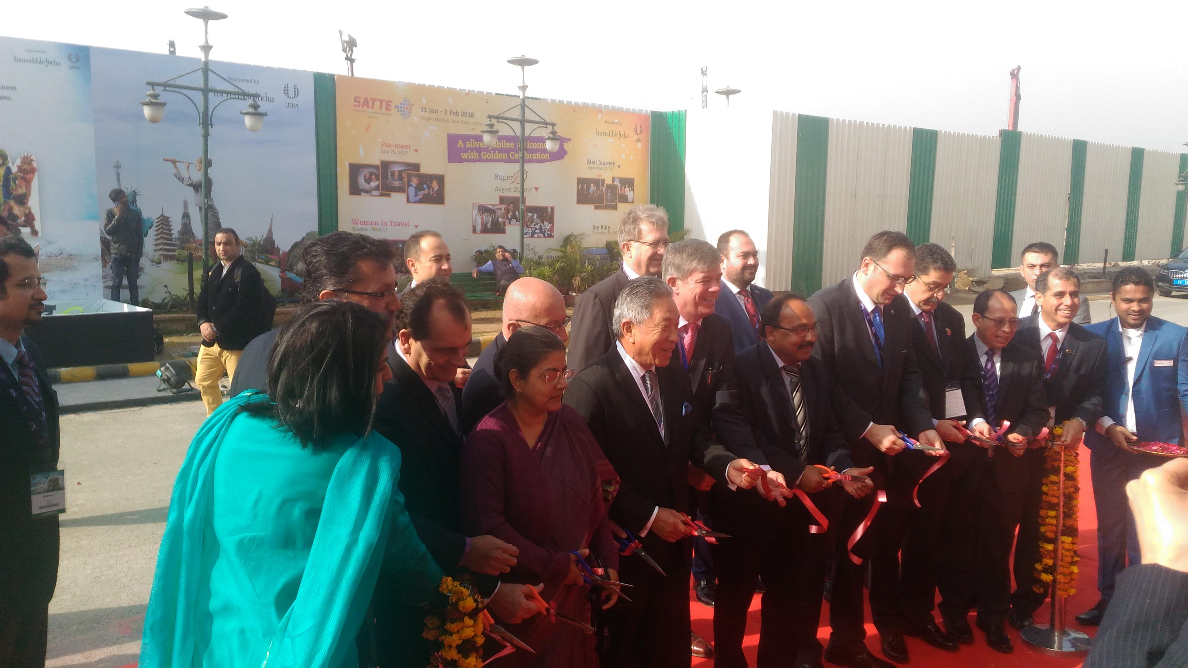 Amb. Tien (left 6) held ribbon cutting alone with VIPs.