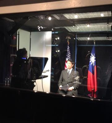 Representative Lyushun Shen in a studio for an interview with the American Veterans Center on February 6, 2014 for the documentary “Doolittle’s Raiders: A Final Toast.” Behind him are the US and the ROC national flags. 