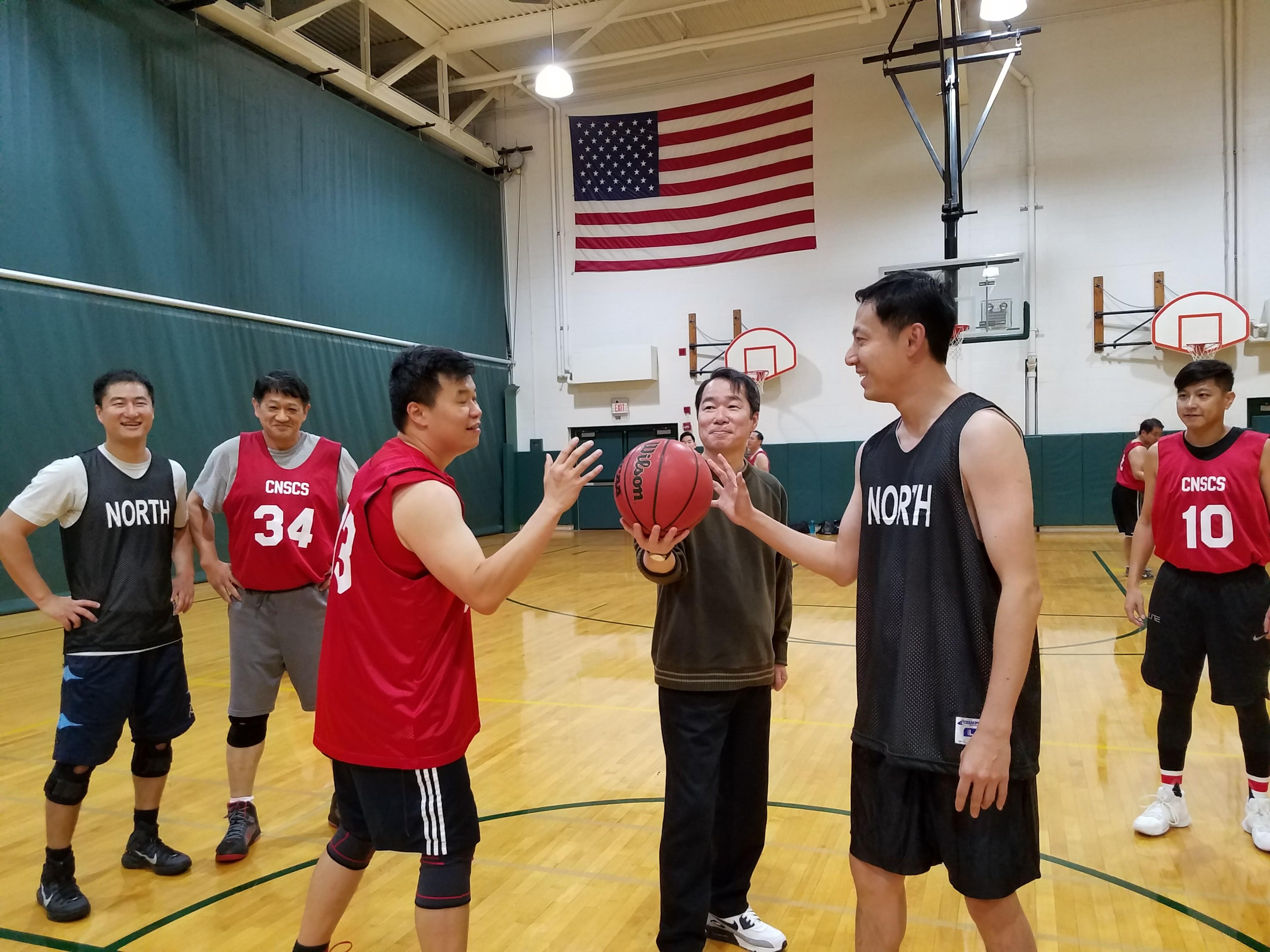 D.G. Calvin Ho tossed ball to start the basketball game.
