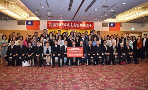 日本の僑胞界が台湾のWHOおよび2018年のWHO年次総会への参加を支持する総意を記したパネルと共に、懇親会の出席者一同。
謝長廷・駐日代表（写真前列左８）、張仁久・駐日副代表（前列左６）、郭仲煕・駐日副代表（前列右５）。