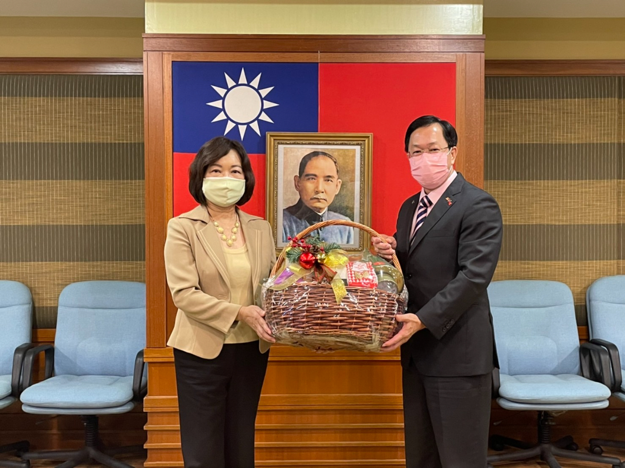 Representative Anne Hung presents a Christmas gift