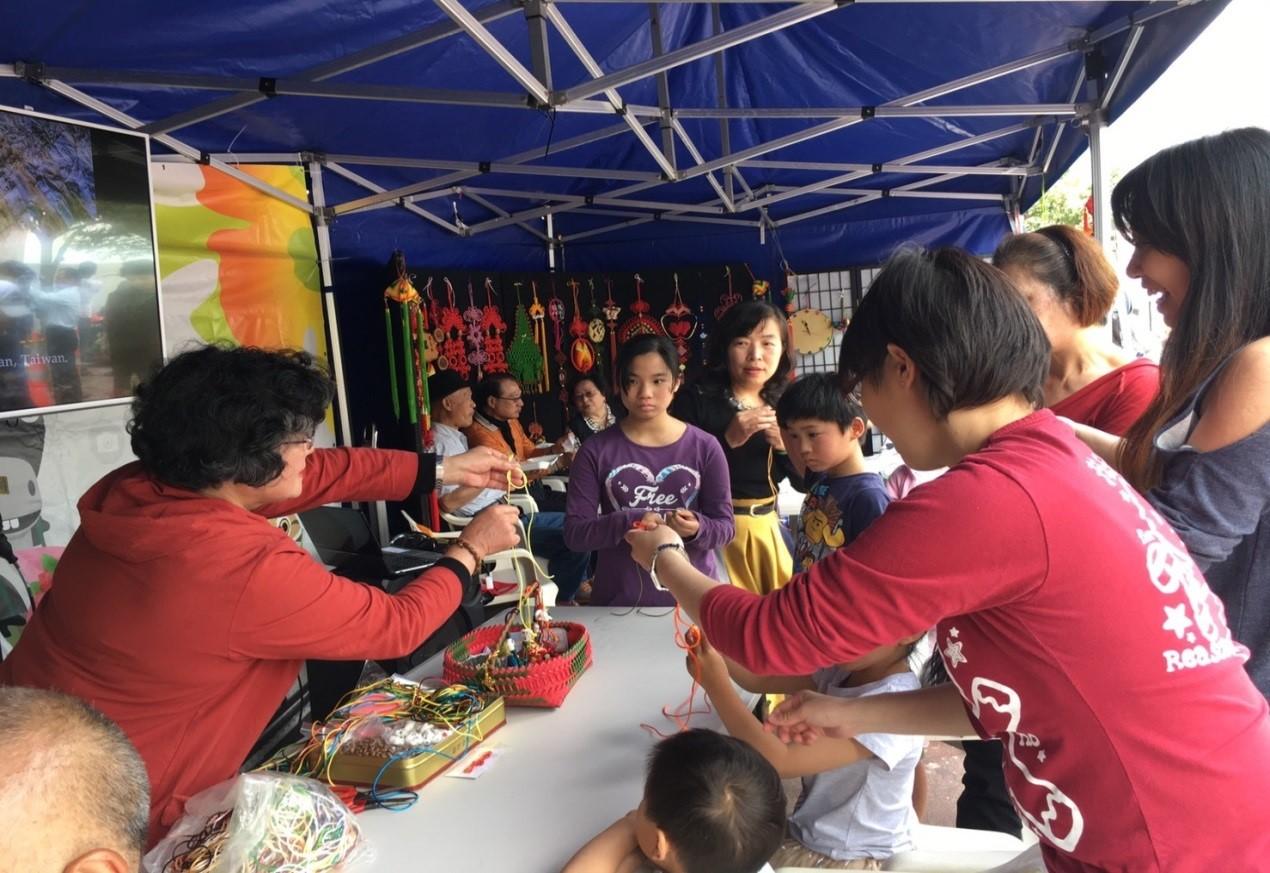 Visitors learning how to make Traditional Chinese Knots