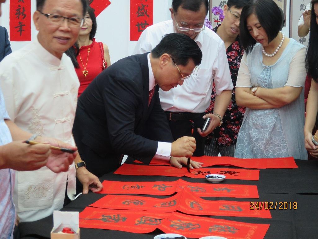 Representative Liang writing his Chinese new year greetings.